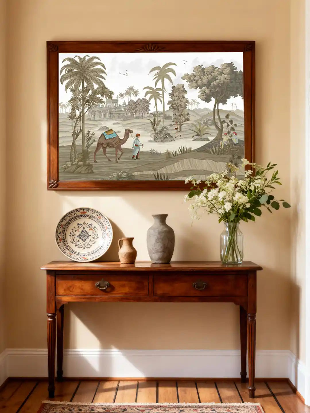 A large-scale Jaisalmer desert mural displayed in a sunlit foyer above a classic wooden console table with ceramic decor.