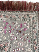 Macro view of the ornate border showing gold sequins, white pearls, and the premium silk fringe texture